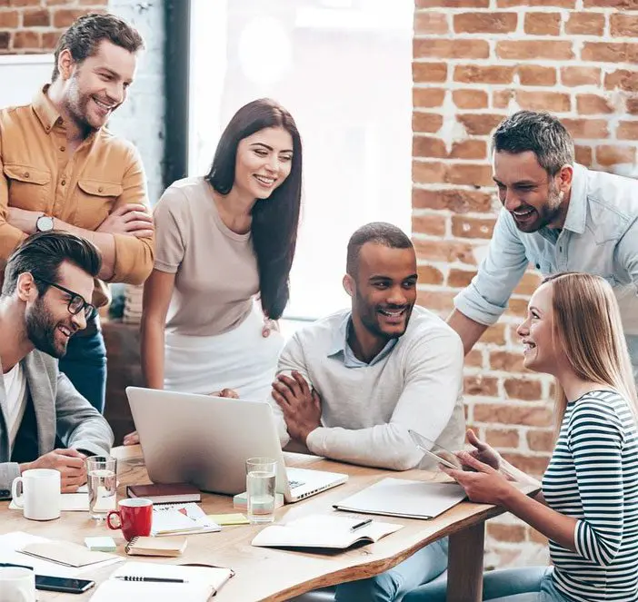 A group of people sitting around a table.